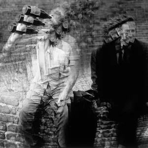 Two homeless men sitting on a wall Two homeless men sitting on a wall