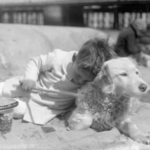 Little boy and his dog on a sandy beach Little boy and his dog on a sandy beach