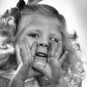 Little girl hands to face calling out Little girl hands to face calling out