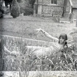 Model posing in a graveyard Model posing in a graveyard