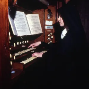 Monastic life - nun playing the organ Monastic life - nun playing the organ