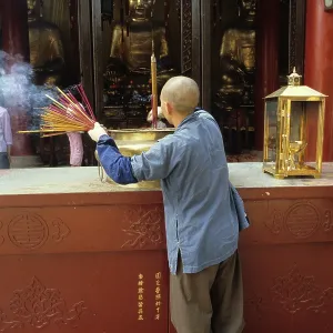 Monk and incense, Temple of the Six Banyan Trees Monk and incense, Temple of the Six Banyan Trees