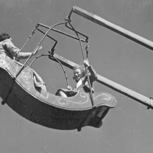 Mother and daughter on a fairground ride Mother and daughter on a fairground ride