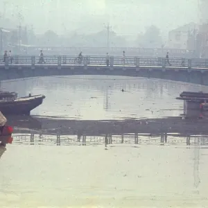 People crossing a bridge over the river, Tokyo, Japan People crossing a bridge over the river, Tokyo, Japan