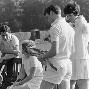 Four police officers playing mixed doubles tennis Four police officers playing mixed doubles tennis
