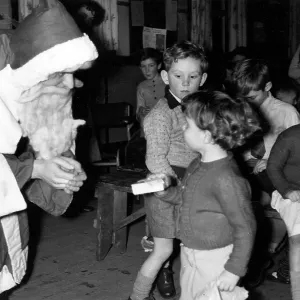 SANTA HANDS OUT PRESENTS SANTA HANDS OUT PRESENTS