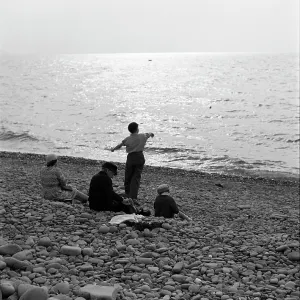 Skimming stones on a pebble beach Skimming stones on a pebble beach