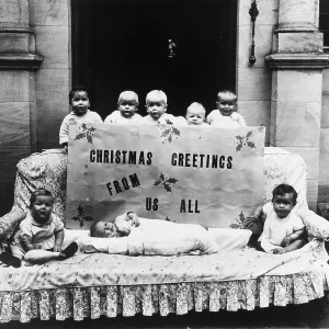 Small children posing with large Christmas card Small children posing with large Christmas card