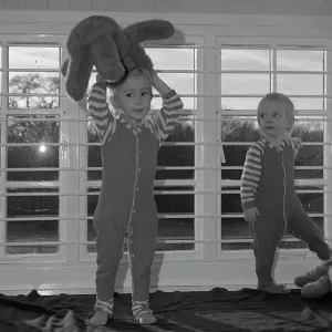 Two small children with teddy bears in a nursery Two small children with teddy bears in a nursery