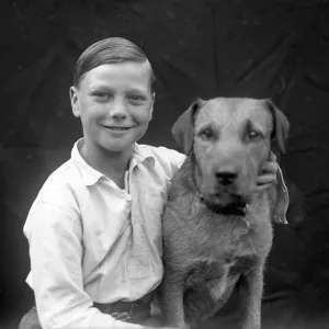 A smiling boy and his terrier dog A smiling boy and his terrier dog