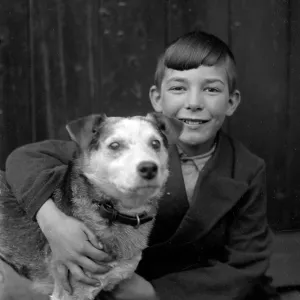 A smiling boy and his terrier dog A smiling boy and his terrier dog
