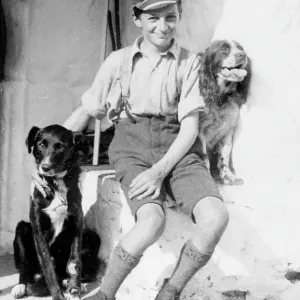 A smiling schoolboy and his two dogs A smiling schoolboy and his two dogs