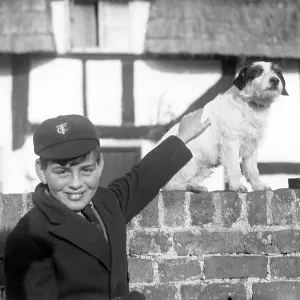 A smiling schoolboy and his terrier dog A smiling schoolboy and his terrier dog
