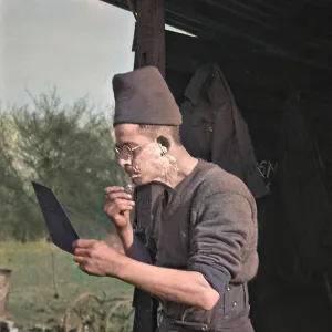 Soldier shaving in the open air at a camp Soldier shaving in the open air at a camp
