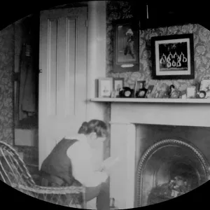 Student reading in study by a fire