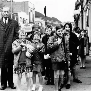Teacher and children with lollypops on an outing Teacher and children with lollypops on an outing