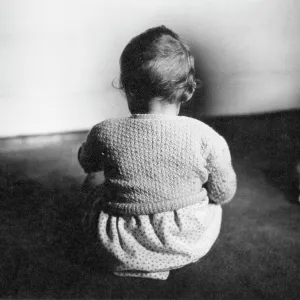Toddler sitting on a carpet Toddler sitting on a carpet