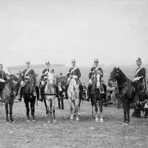 Uniformed men on horseback in a field Uniformed men on horseback in a field