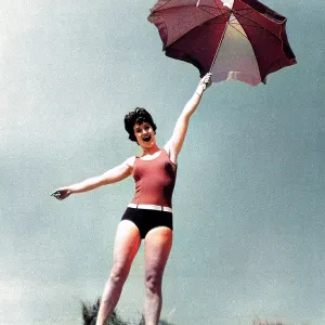 Woman on beach with sunshade Woman on beach with sunshade