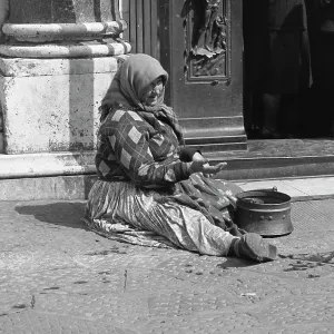 Woman begging in front of a church Woman begging in front of a church
