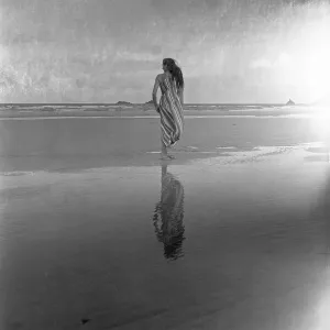 Woman on a twilight beach Woman on a twilight beach