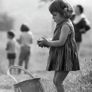 Young girl in a park with grass in her hands Young girl in a park with grass in her hands