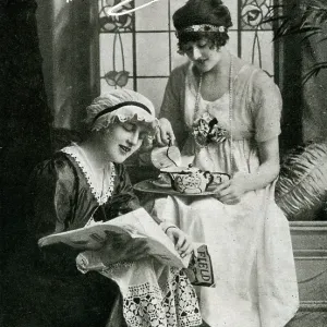 Two young ladies enjoying a cup of tea Two young ladies enjoying a cup of tea