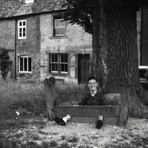 Young man fooling about in The Stocks Young man fooling about in The Stocks