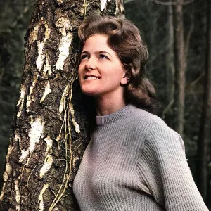 Young woman leaning against a tree Young woman leaning against a tree