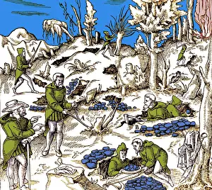 Divination: 16th century men using divining rods to locate minerals