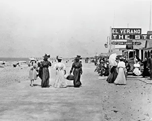 Asp001: 1910s 1912 People Strolling Away on Paved Walk Along Beac