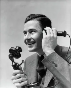 Businesspeople: 1920s 1930s MAN TALKING ON CANDLESTICK PHONE