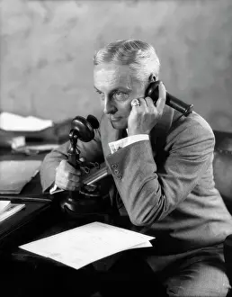 Businesspeople: 1920s Businessman At Desk Talking