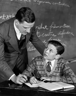 Diligence: 1920s Classroom Male Teacher Helping