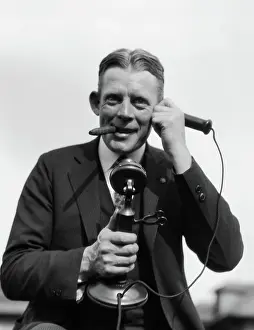 Telephoning: 1920s PORTRAIT OF BUSINESSMAN TALKING ON CANDLESTICK