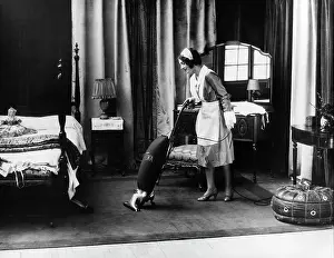 Vacuuming: 1920s uniformed maid running eureka vacuum