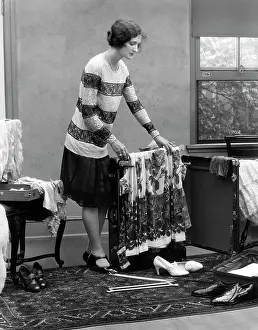 Unpacking: 1920s Woman Packing Clothes For