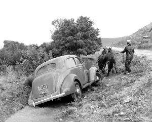 Teamster: 1930s 1937 ford v-8 being pulled out of rural