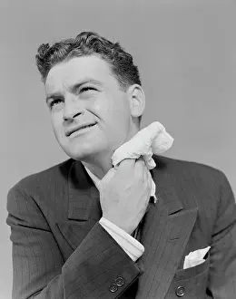 Perspiration: 1930s 1940s MAN UNCOMFORTABLE GRIMACE SWEATING