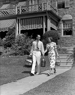Hikes: 1930s Couple Walking Out Of House