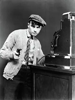 Hopelessness: 1930s desperate man robber pointing gun taking