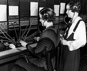 Dialing: 1930s female telephone switchboard operator and