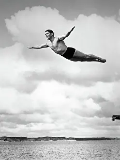Grownups: 1930s MAN SWAN DIVING FROM HIGH DIVING BOARD