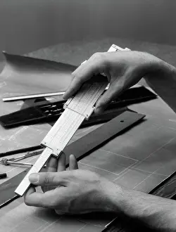 Drafting: 1930s MAN'S HANDS USING SLIDE RULE OVER DRAFTING