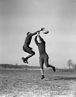 Interception: 1930s Two Men Jumping To Catch