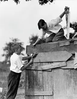 Nailing: 1930s Pair Of Boys Building Shack