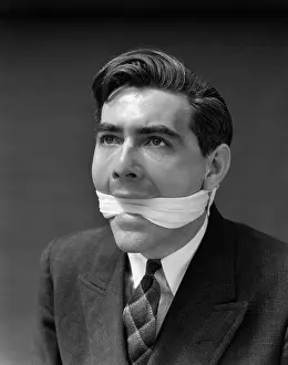 Speechless: 1930s Portrait Of Man With Gag