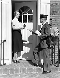 Knocker: 1930s Postman Giving A Letter