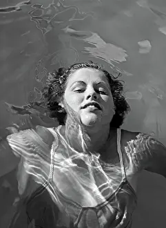 Grownups: 1930s SMILING WOMAN IN BATHING SUIT FLOATING
