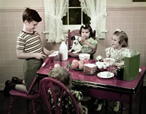 Peanut: 1940s 1950s boy making peanut butter sandwich